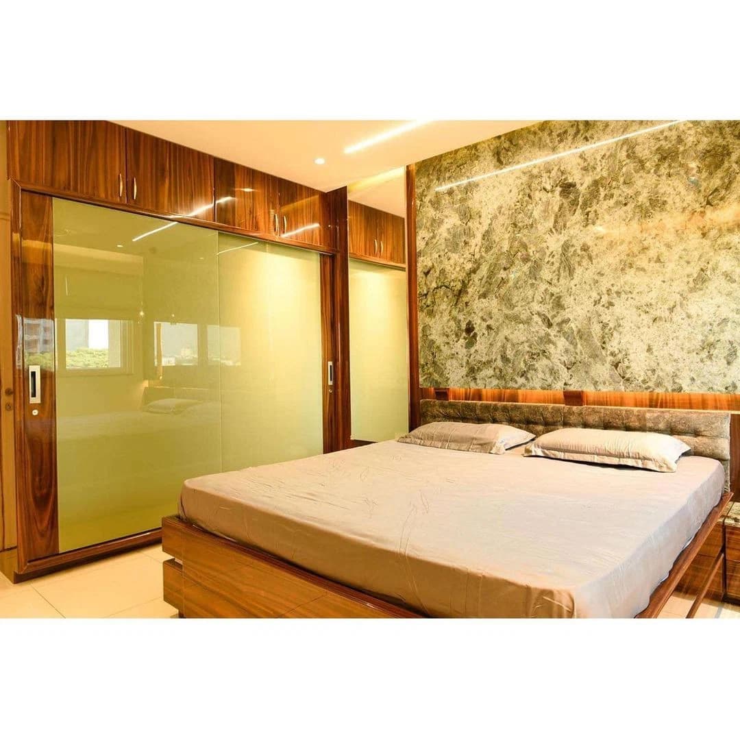 Bedroom with bed and marble-textured feature wall