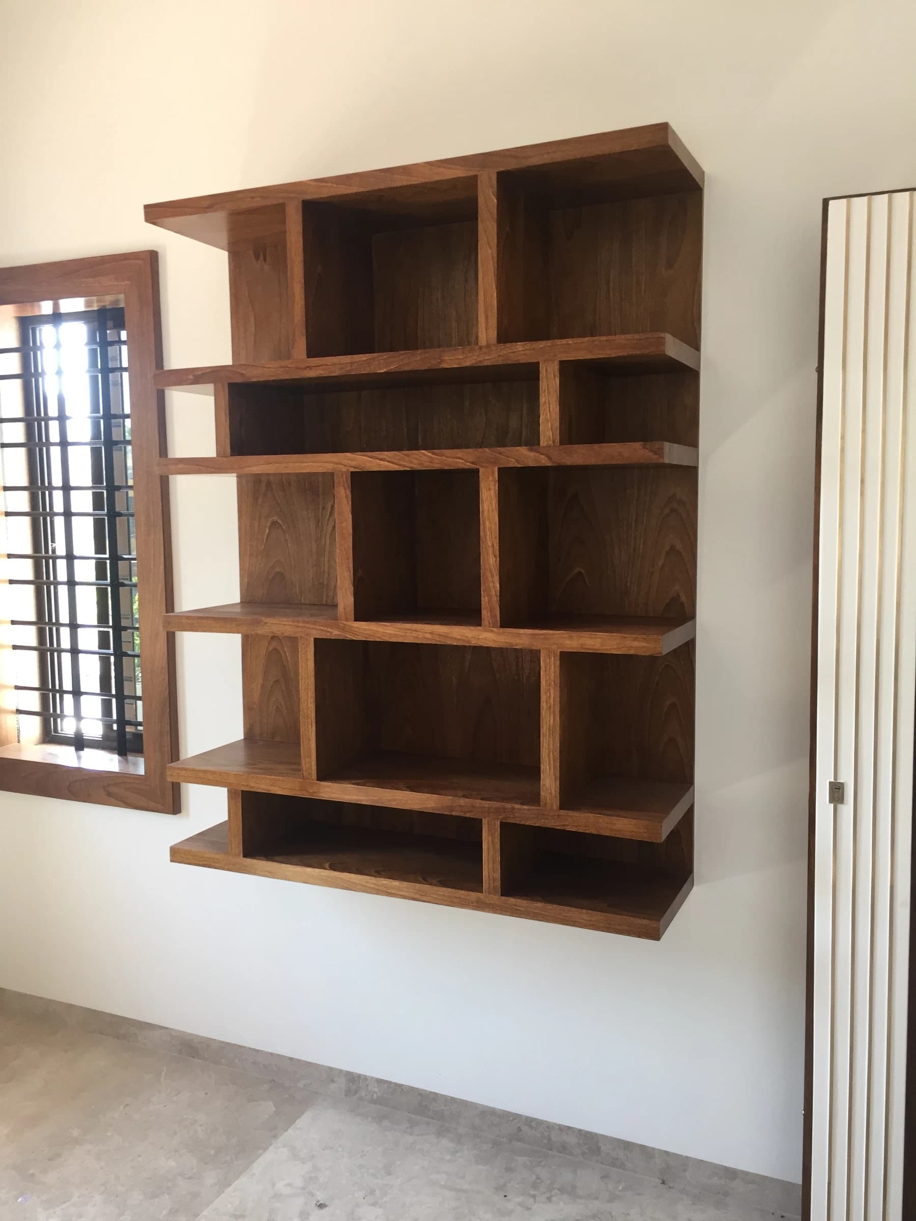 Wall-mounted shelving beside a window